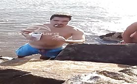 Latino pissing on the beach