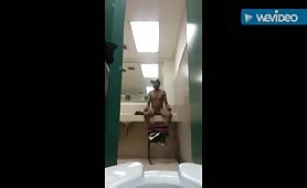 Horny black guy masturbating in the urinals of a public restroom of a restaurant