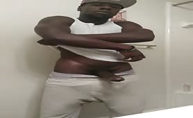 Black thug strokes his beefy huge cock in the bathroom
