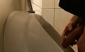 Stroking my cock in the public urinal