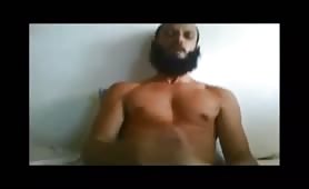 Arab with a long beard strokes his cock solo