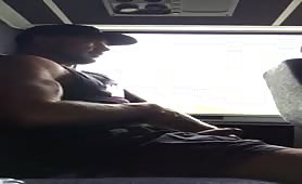 Muscular stud stroking his cock in public Bus