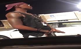 Black thug pissing and rubbing his cock in a parking lot