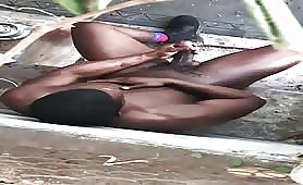 Muscular black guy rubbing his cock completely naked in his back yard