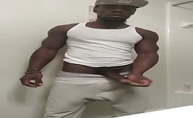 Black thug strokes his beefy huge cock in the bathroom