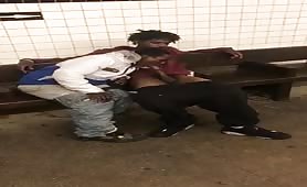 Two homeless black men having oral fun at a subway station